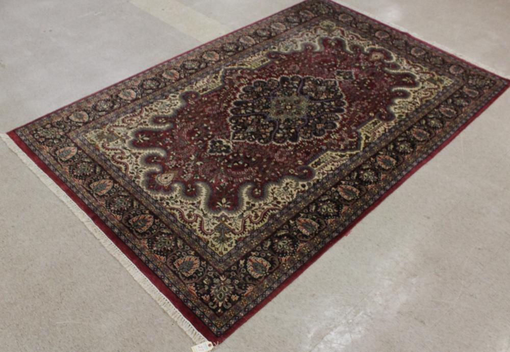 Appraisal: HAND KNOTTED ORIENTAL CARPET Indo-Persian floral and central floral design