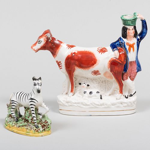 Appraisal: LARGE STAFFORDSHIRE COW CREAMER AND A FIGURE OF A ZEBRAUnmarked