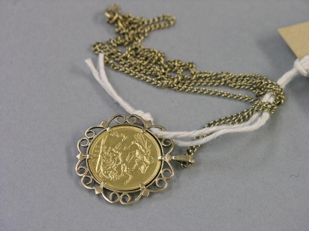 Appraisal: A gold sovereign within gold scroll mount pendant on chain