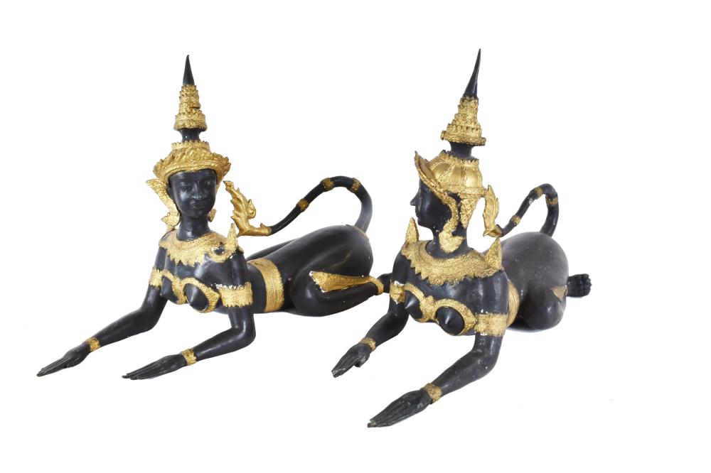 Appraisal: PAIR OF THAI PARCEL GILT EBONIZED METAL SPHINXESThe figures in