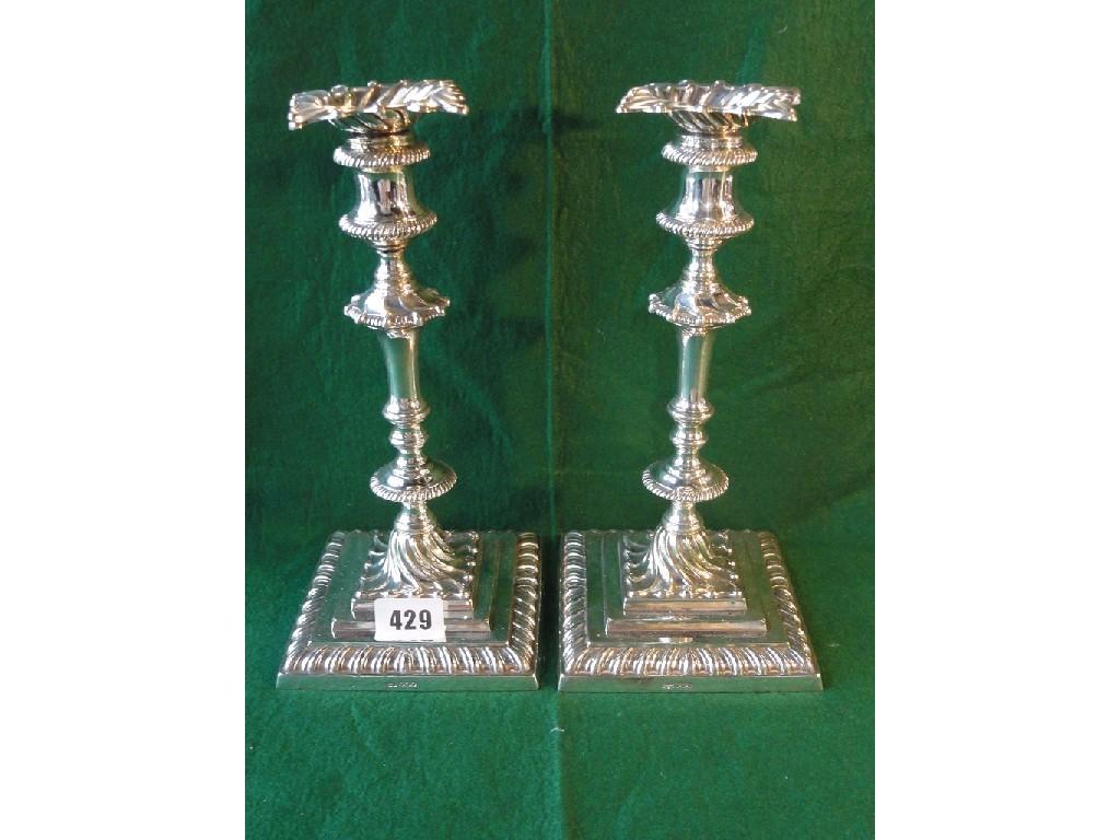 Appraisal: A fine pair of Georgian style candlesticks with square scrolled