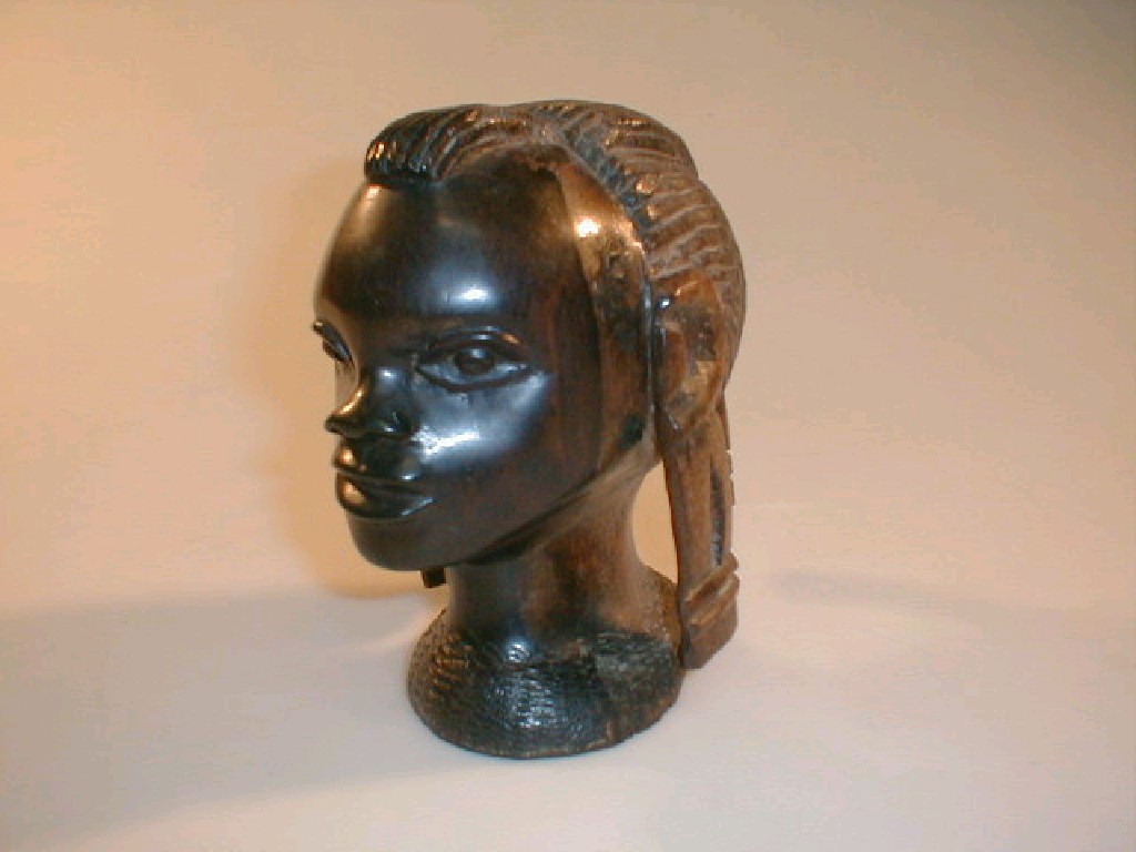 Appraisal: A North African rosewood tribal carving of a female head