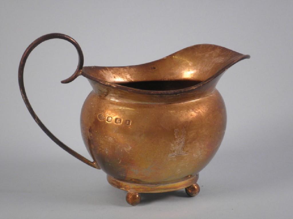 Appraisal: A silver cream jug with a scrolled handle and claw