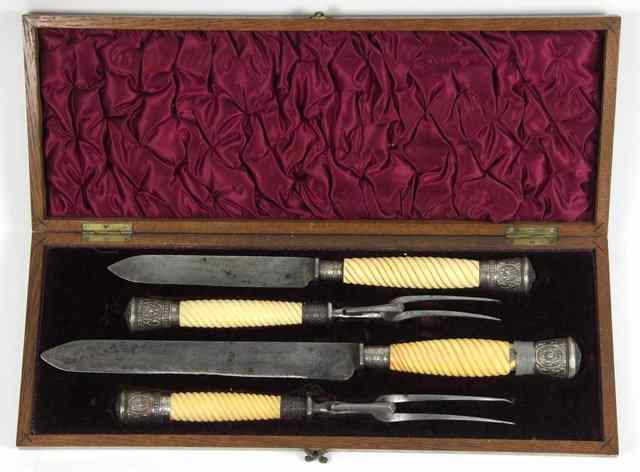 Appraisal: A silver mounted carving set Sheffield fitted ivory handles and