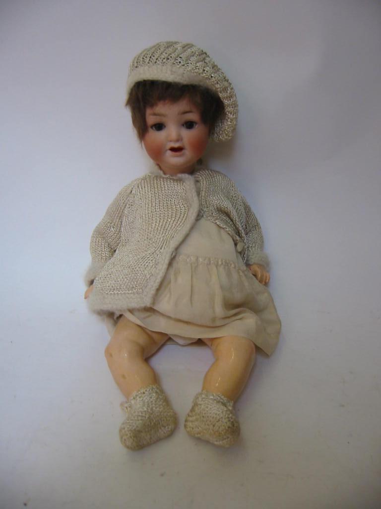 Appraisal: An Ernst Heubach bisque head girl doll with brown glass