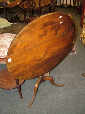 Appraisal: An oak tilt top table th century the circular top