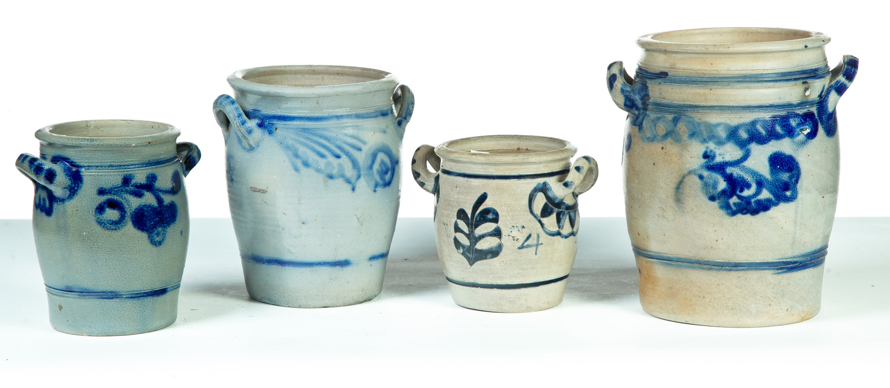 Appraisal: FOUR GERMAN GRADUATED DOUBLE-HANDLED STONEWARE JARS Nineteenth century Salt glaze