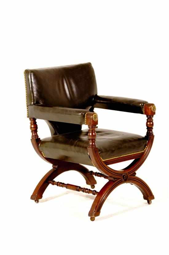 Appraisal: Gillows walnut and leather curule armchair circa shaped leather back