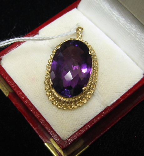 Appraisal: AMETHYST AND FOURTEEN KARAT GOLD PENDANT centering a large oval