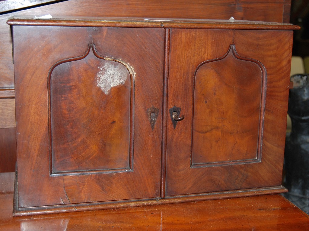 Appraisal: A Victorian mahogany slide cabinet having Arabic arched panelled doors