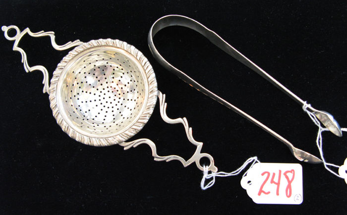 Appraisal: TWO STERLING SILVER ITEMS a tea strainer with side handles