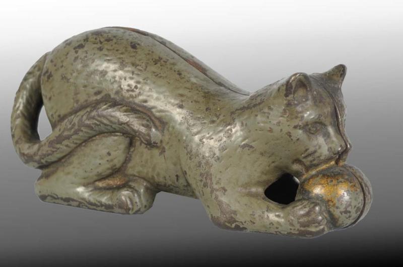 Appraisal: Cast Iron Cat with Ball Still Bank Description Circa Manufactured