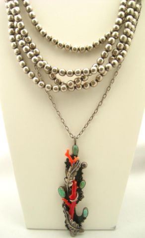 Appraisal: Two southwestern necklaces including leaf motif turquoise and coral necklace