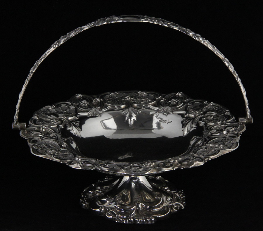 Appraisal: A swing-handled silver fruit bowl Walker Hall Sheffield with foliate