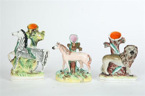 Appraisal: THREE STAFFORDSHIRE FIGURAL BUD VASES A zebra h A horse