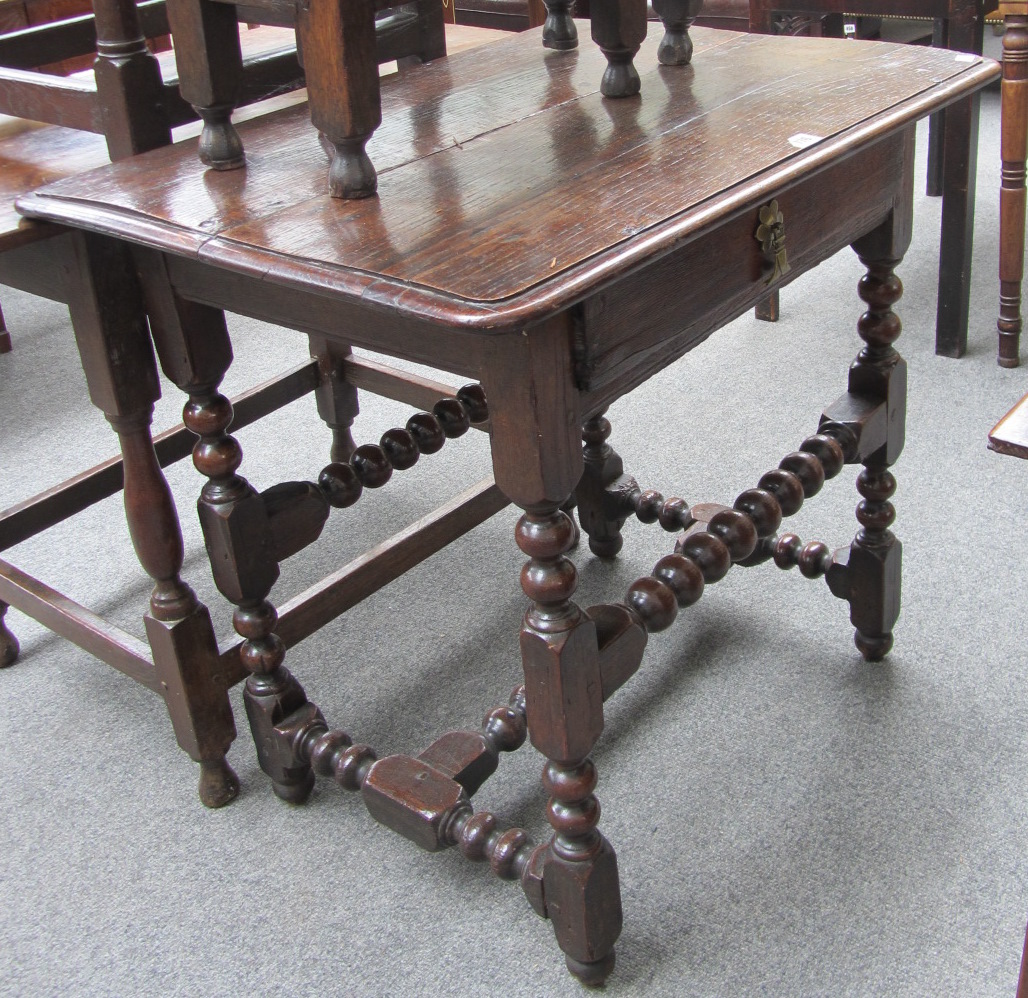 Appraisal: A Charles II and later oak single drawer side table