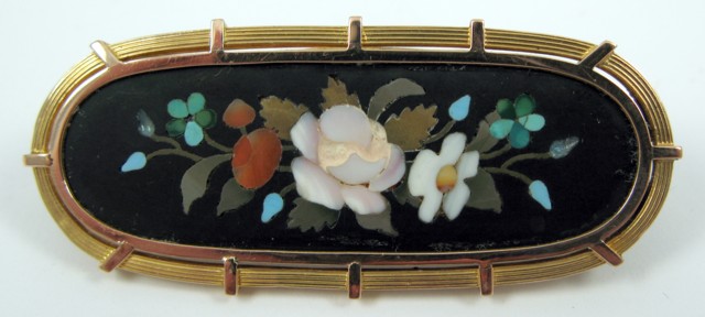 Appraisal: INLAID GEMSTONE AND YELLOW GOLD BROOCH The - oval brooch