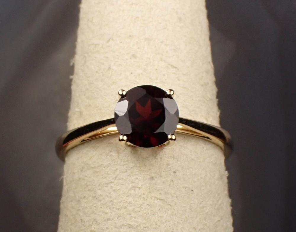 Appraisal: PYROPE GARNET AND FOURTEEN KARAT GOLD RING with four yellow