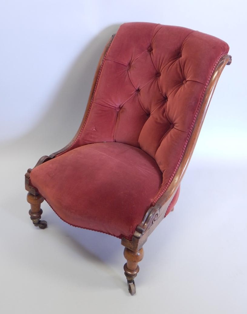 Appraisal: A Victorian mahogany nursing chair with a button back and