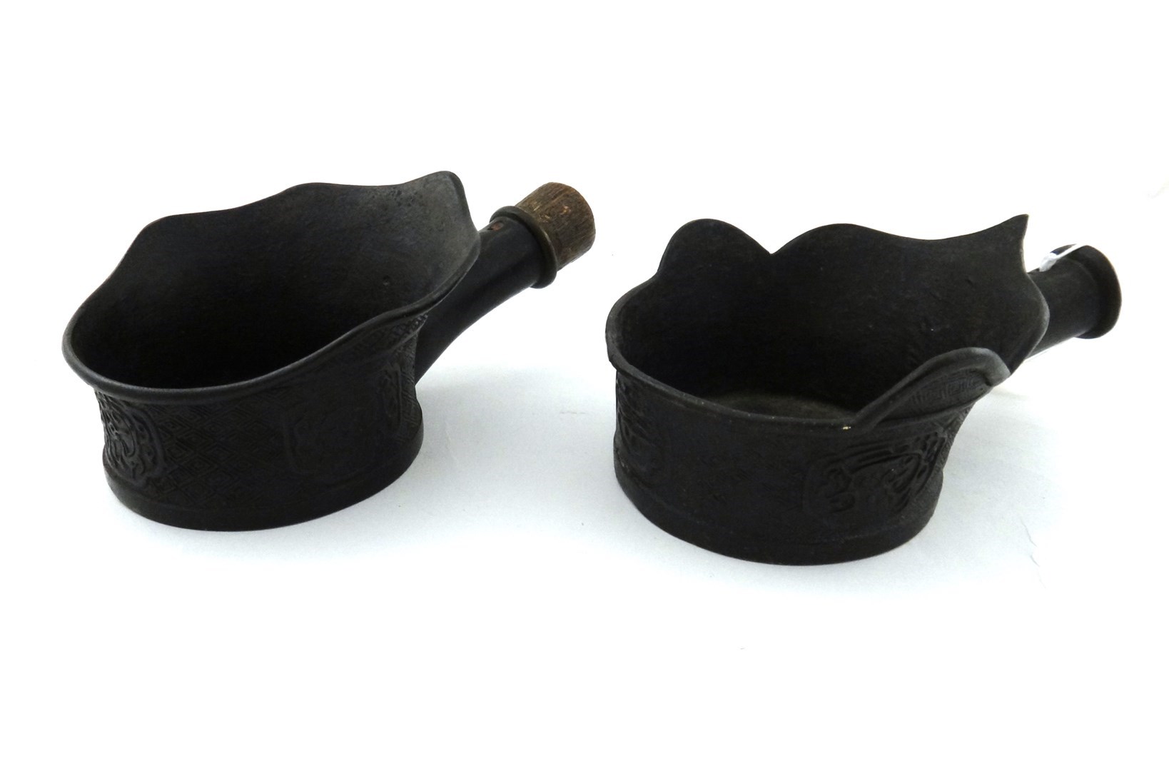 Appraisal: A pair of Chinese bronze pan irons probably th century