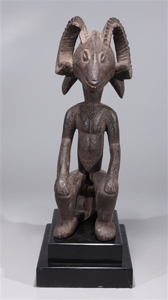 Appraisal: African carved wood Kuba seated figure with ram head with