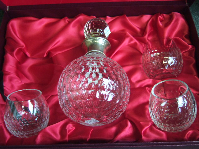 Appraisal: A glass decanter with silver collar three matching glasses a