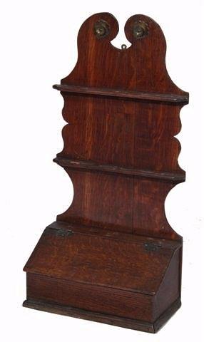 Appraisal: A GEORGIAN OAK SPOON RACK with shaped bracket and hinged