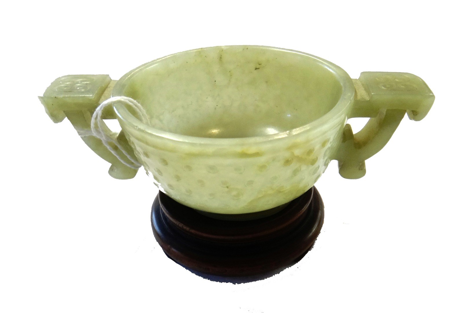 Appraisal: A Chinese celadon jade archaistic two-handled cup th th century