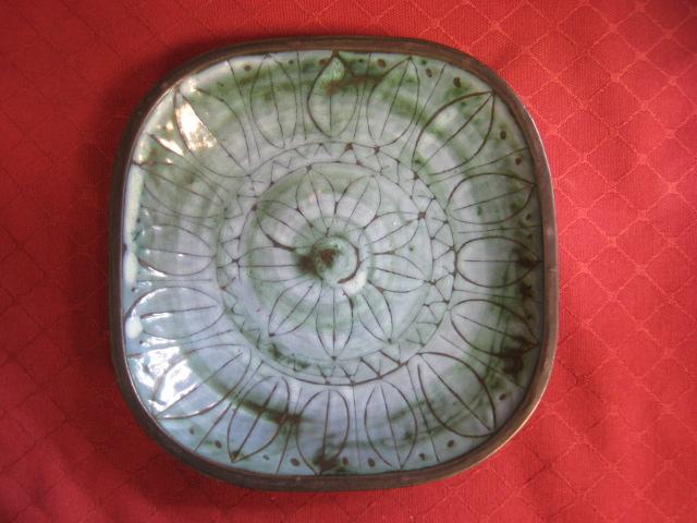 Appraisal: A Troika Dish sgraffito flower head design blue green glaze