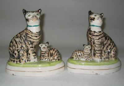 Appraisal: A PAIR OF STAFFORDSHIRE POTTERY TOM CAT AND KITTENS GROUP