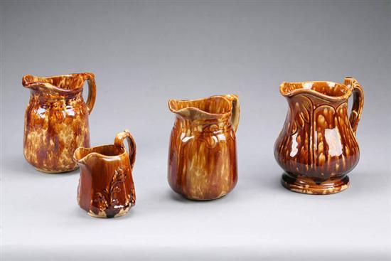 Appraisal: FOUR ROCKINGHAM PITCHERS Two with Gothic design one with paneled