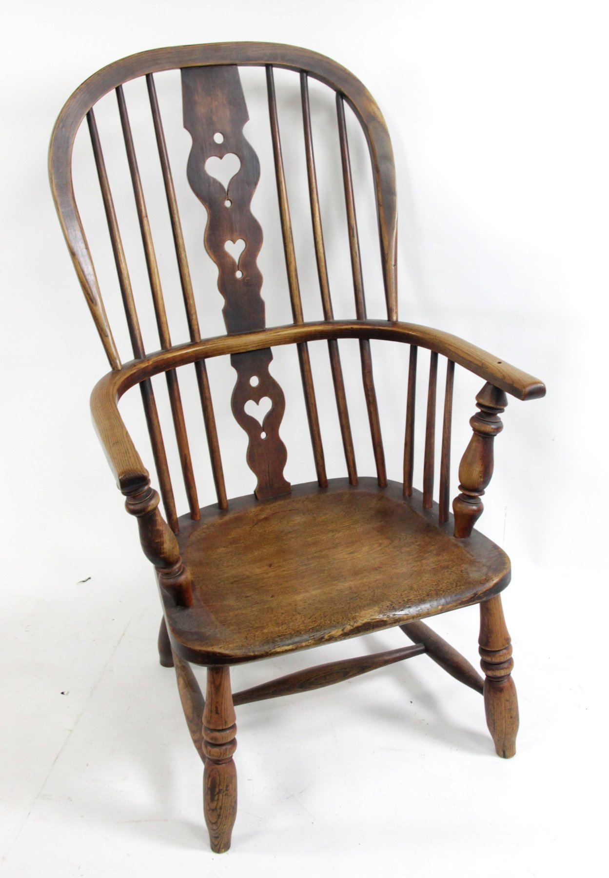 Appraisal: A Windsor armchair with pierced hearts to the splat and