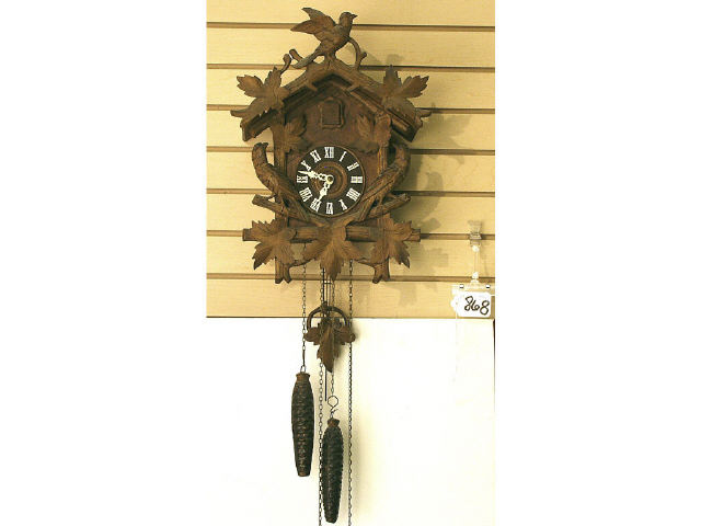 Appraisal: Hand carved Black Forest cuckoo clock features bird motif weights