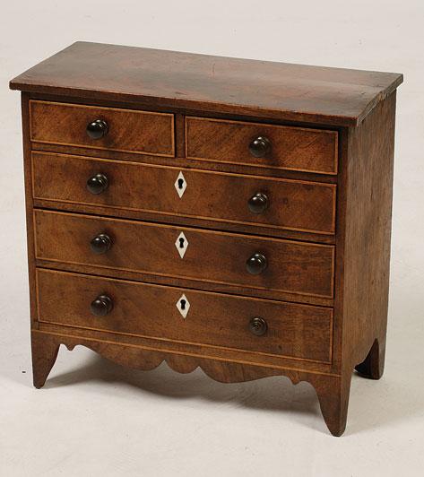 Appraisal: A GEORGE III MINIATURE CHEST OF DRAWERS the rectangular top