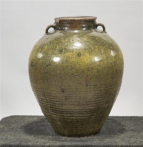 Appraisal: Large green and black glazed ceramic jar with handles to