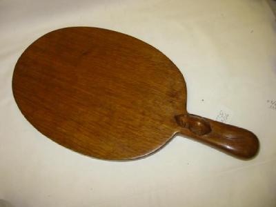 Appraisal: AN ADZED OAK CHEESE BOARD by Robert Mouseman Thompson of