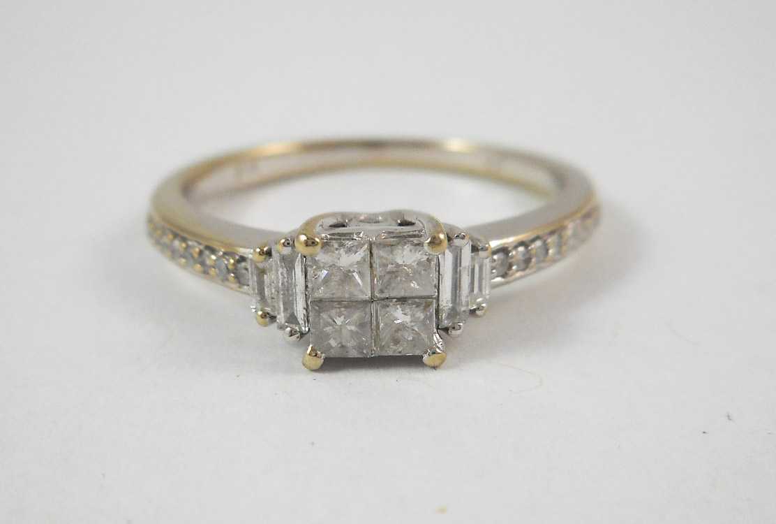 Appraisal: DIAMOND AND TEN KARAT WHITE GOLD RING with two baguette