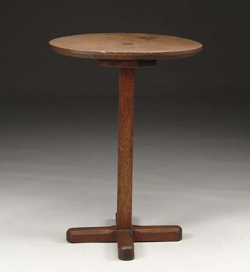 Appraisal: COLONIAL PILGRIM OAK OVAL TOP CROSS BASE CANDLESTAND The oval