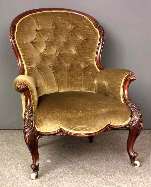 Appraisal: A th Century French walnut carved spoon back easy chair