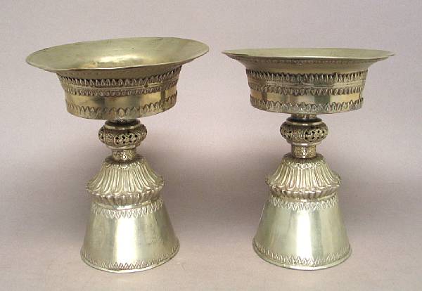 Appraisal: A pair of Tibetan pieced silver butter lamps With reticulated