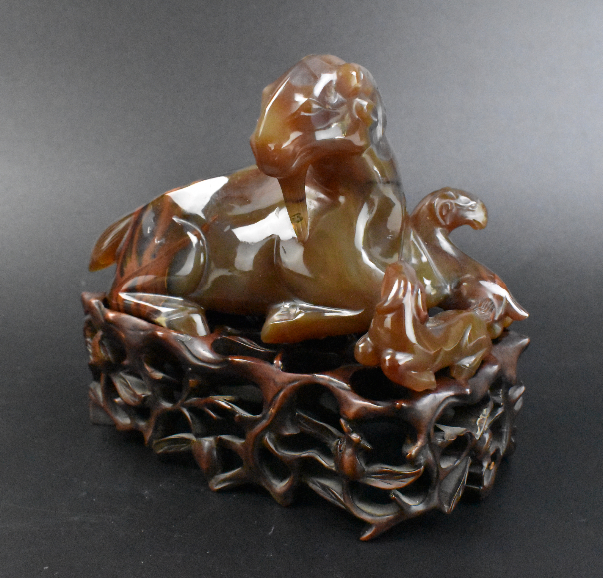 Appraisal: A Chinese agate carving of three goats on a carved