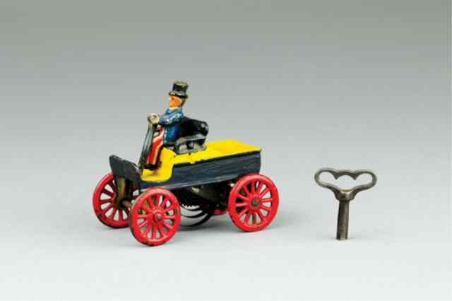 Appraisal: SMALL CLOCKWORK TILLER CAR WITH PATRIOTIC DRIVER Cast iron painted