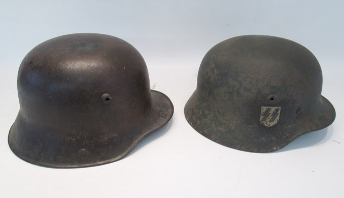 Appraisal: TWO WORLD WAR II GERMAN HELMETS the first a painted