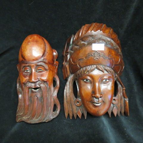 Appraisal: Pair of Chinese Carved Wooden Masks largest is x excellent