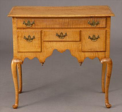 Appraisal: AMERICAN QUEEN ANNE FIGURED MAPLE DRESSING TABLE The molded top