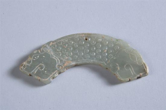 Appraisal: CHINESE CELADON JADE DRAGON Huang Warring States period or later