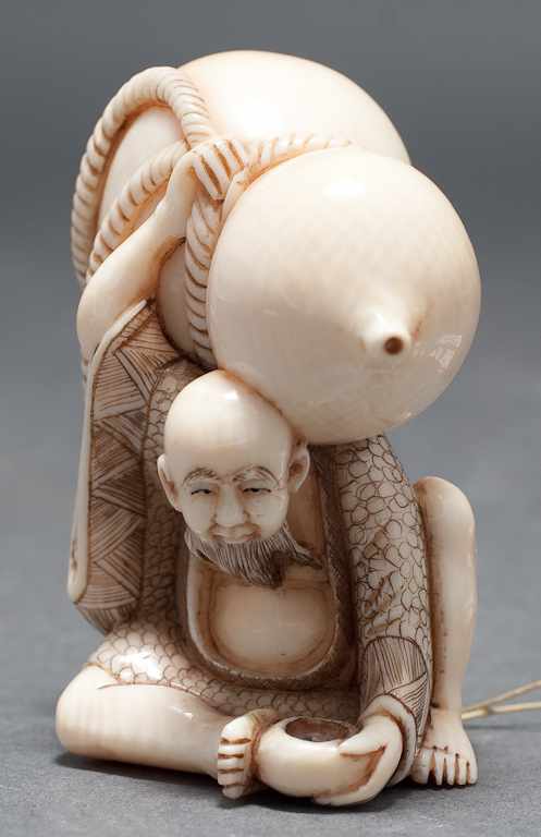 Appraisal: Japanese carved ivory netsuke Man holding a giant double gourd