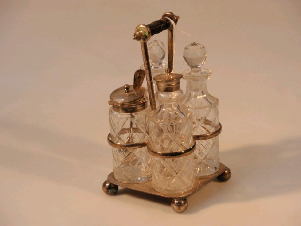 Appraisal: An electroplate cruet stand with four cut glass bottles