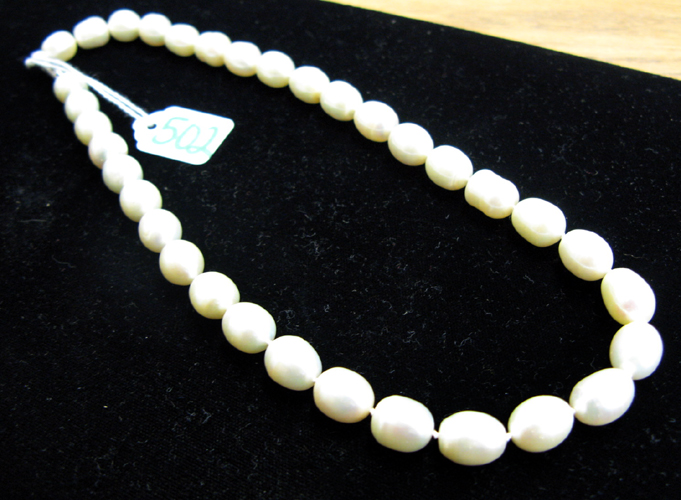 Appraisal: BAROQUE PEARL NECKLACE strung with white pearls with green and