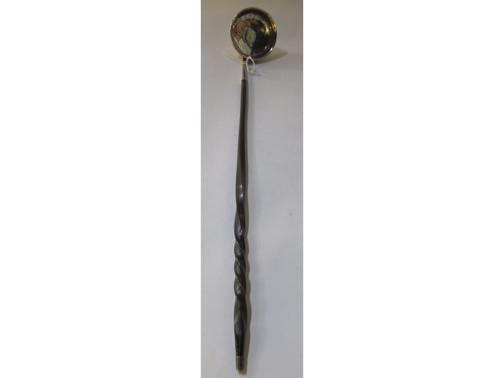 Appraisal: An unmarked silver toddy ladle with whalebone handle